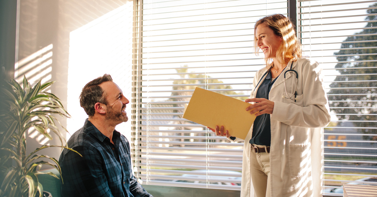 a man and a woman standing in front of a window