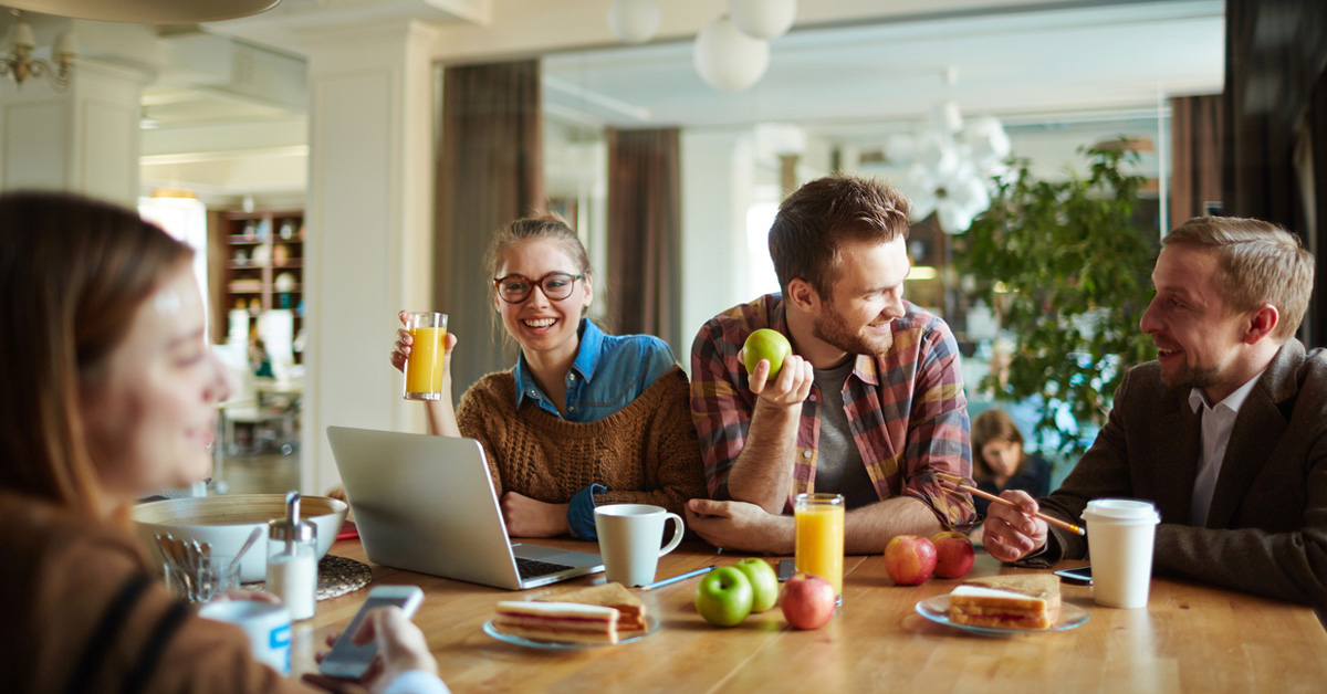 a person sitting at a table using a laptop