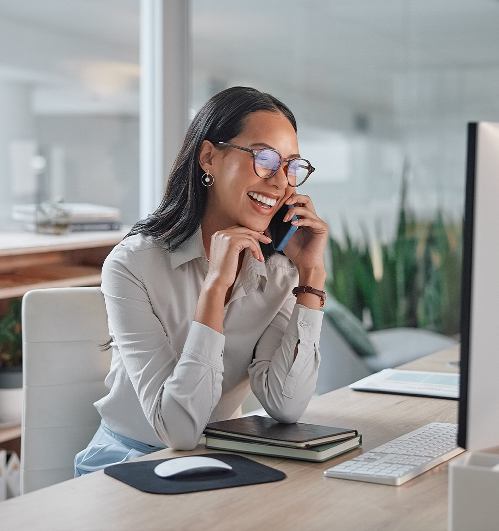 a woman sitting down talking on a cell phone